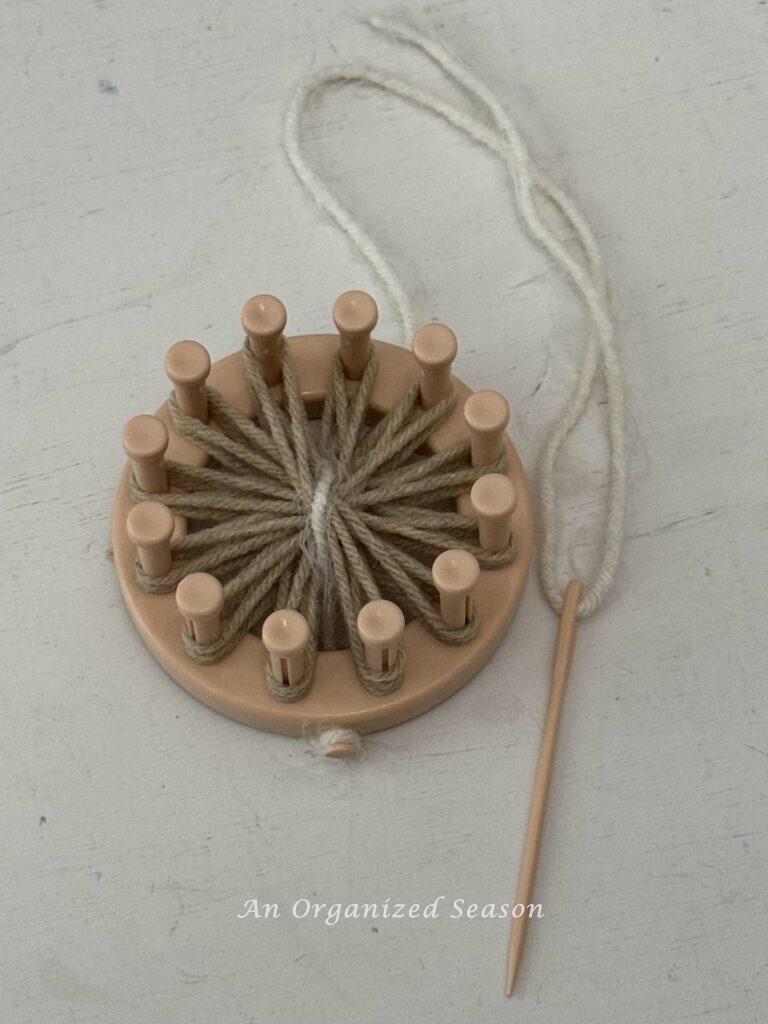 White yarn making the center of a flower. 