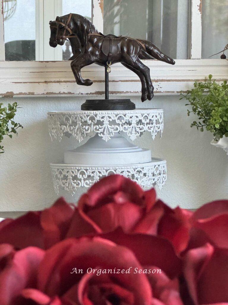 Kentucky Derby Party Idea #5- display a horse statue on two white stacked cake plates.