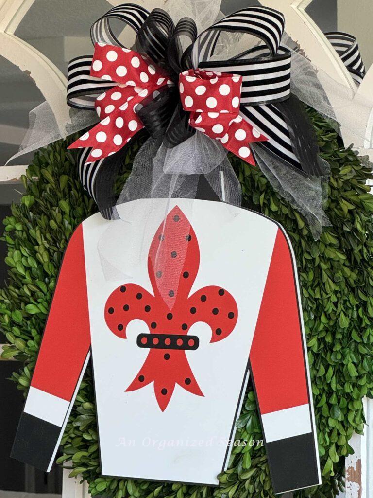 Kentucky Derby Party Idea #3- hang a jockey silk on a boxwood wreath and add a coordinating bow.