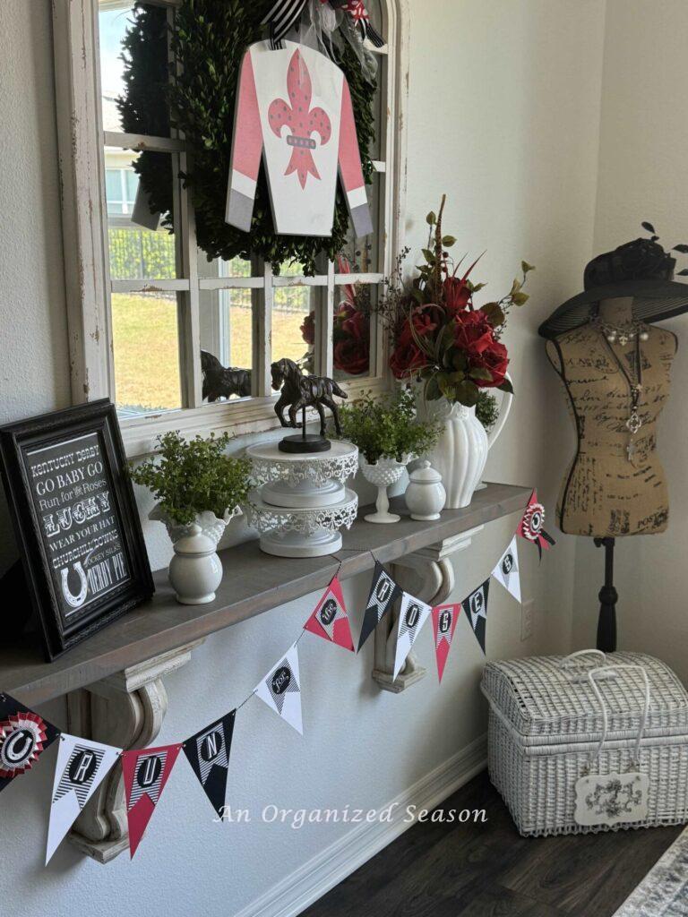 A shelf and mirror decorated for the KY derby. 