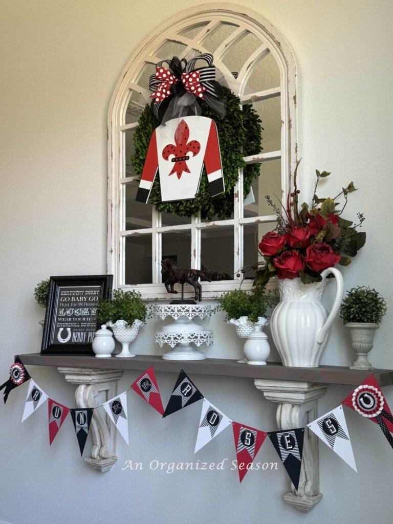 Banner hanging on a decorated shelf that says, "Run for the Roses."