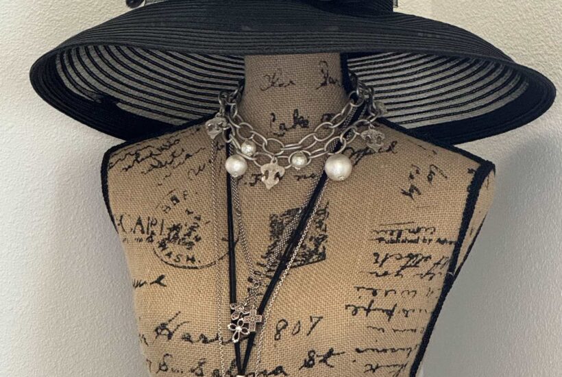 Derby hat on a dress form.