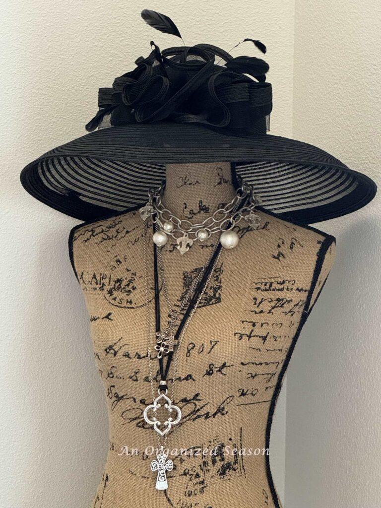 Kentucky Derby Party Idea #2- decorate a dress form with a Derby hat and silver necklaces. 