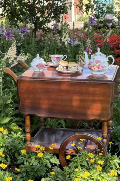 Teas set on a wooden cart in a garden