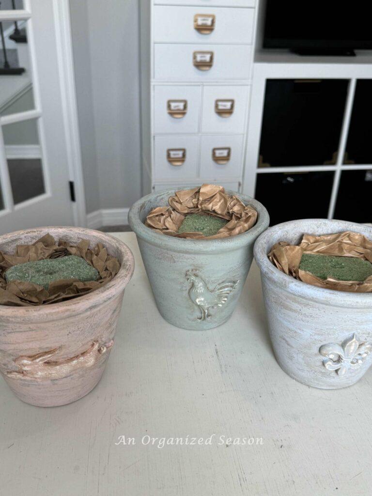 Step two to make a faux topiary is to prepare a pot with styrofoam and packing paper.