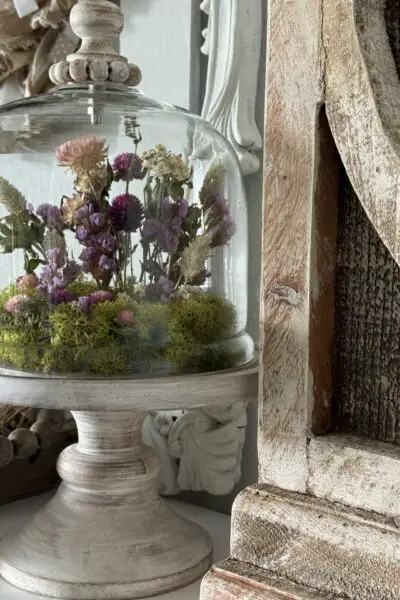 Dried flowers arranged inside a cloche.