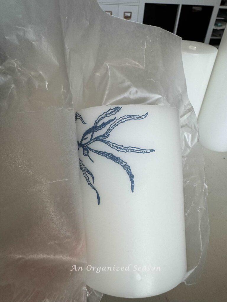 Remove the wax paper from the candle.