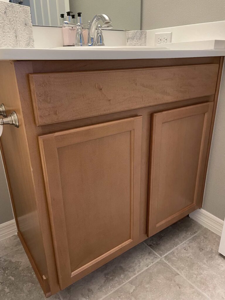A brown bathroom cabinet. 