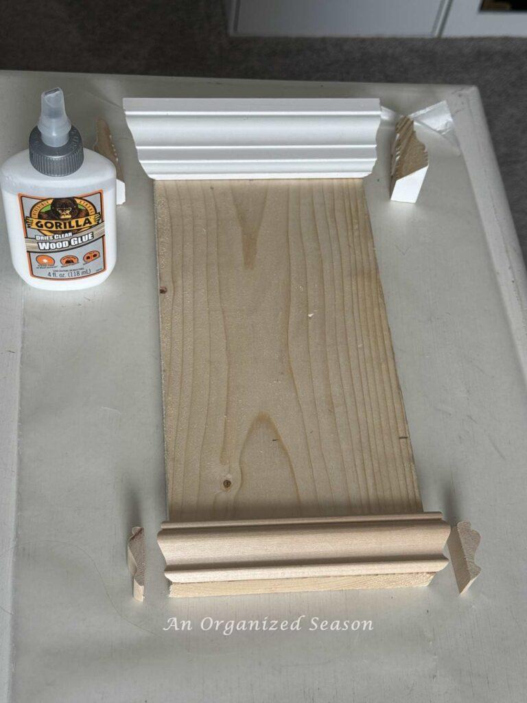 Trim that was glued onto a piece of wood. 