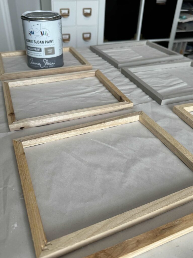 Step four to make DIY seashell wall decor is to paint the wood frames with gray paint. 