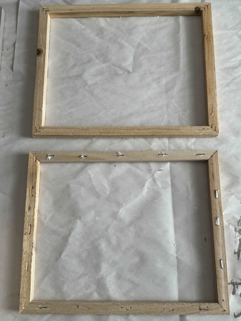 The top and bottom sides of a wood frame without its canvas. 