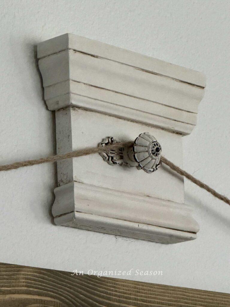 A close up of a DIY wall hook. 