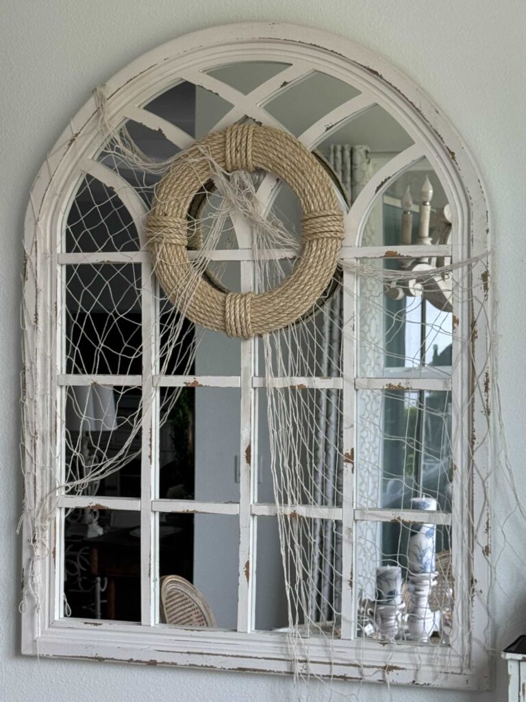 A DIY rope wreath hanging on a mirror. with a fishing net. 