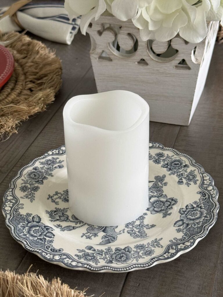 Put a white candle on a blue and white transferware plate  to add patriotic table decor.