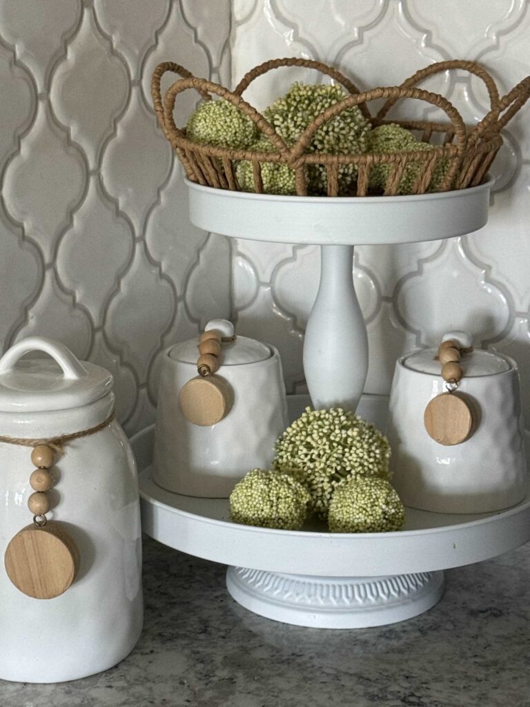 A white tiered tray topped with a scalloped basket.