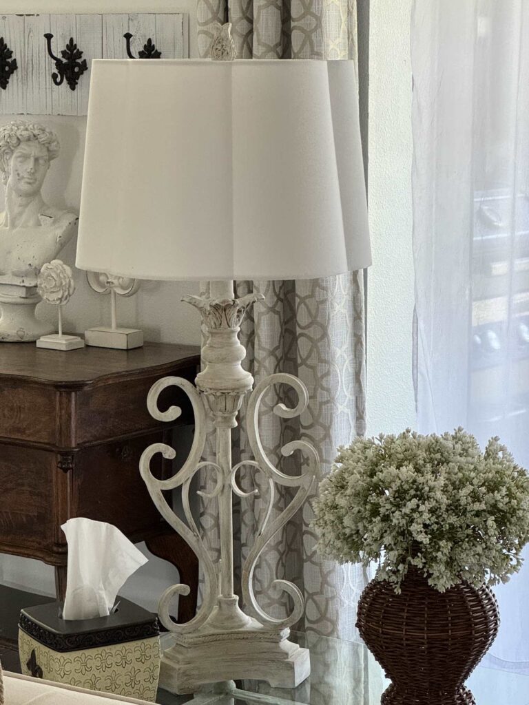 A white lamp with a scalloped shade. 