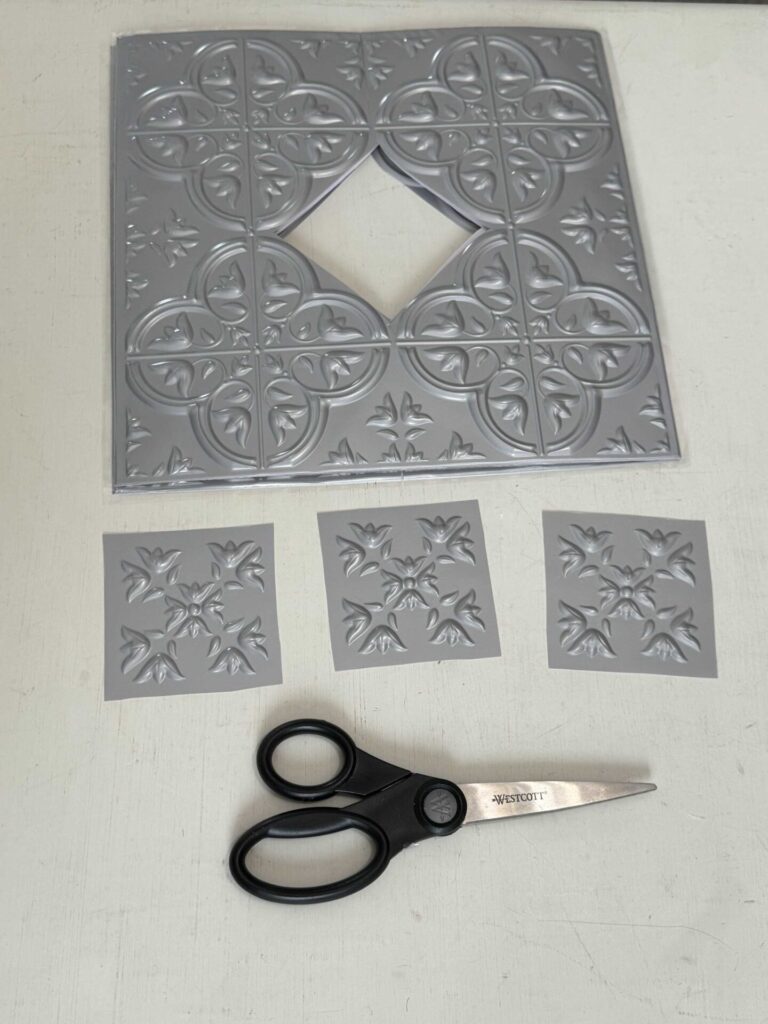 Silver faux tiles with the centers cut out. 