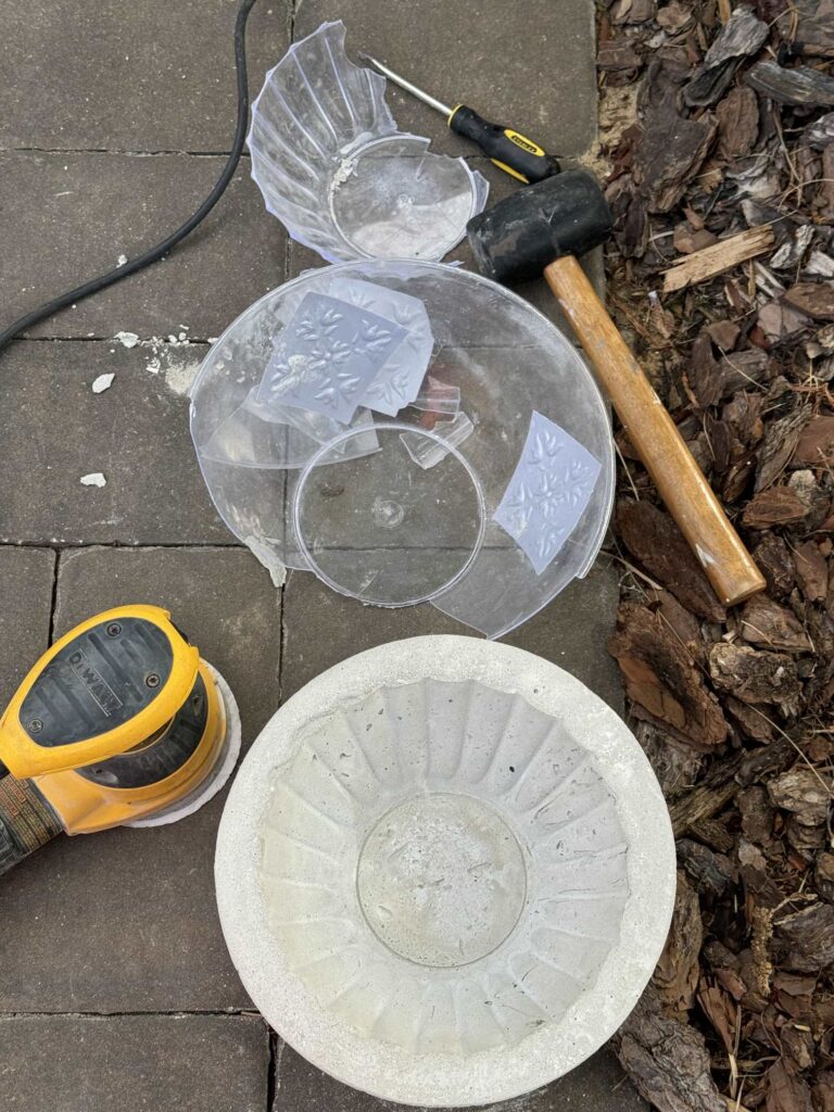 Broken plastic bowls next to a DIY concrete bowl. 