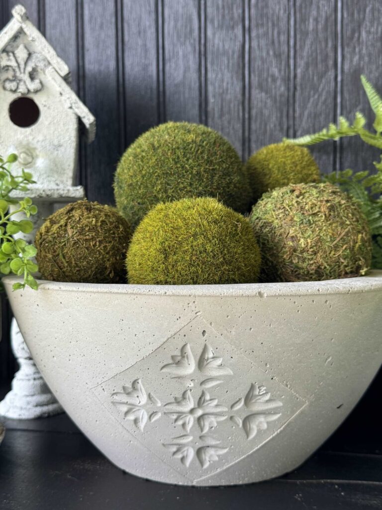 A concrete bowl with a design on the front. 