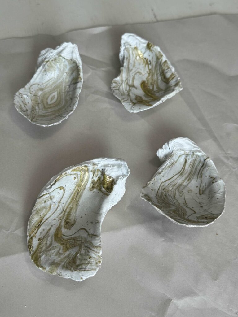 Four DIY decoupage oyster shells. 