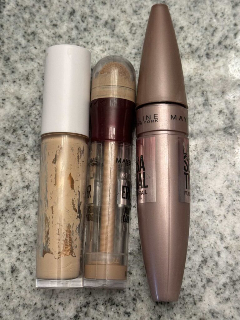 Step two to organize makeup is to discard old, empty, or expired makeup like these concealers and mascara. 