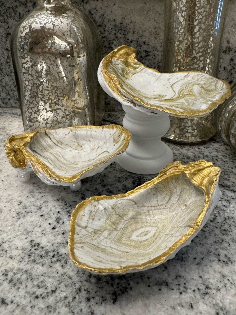 Three decoupage oyster shells made into trinket dishes. 