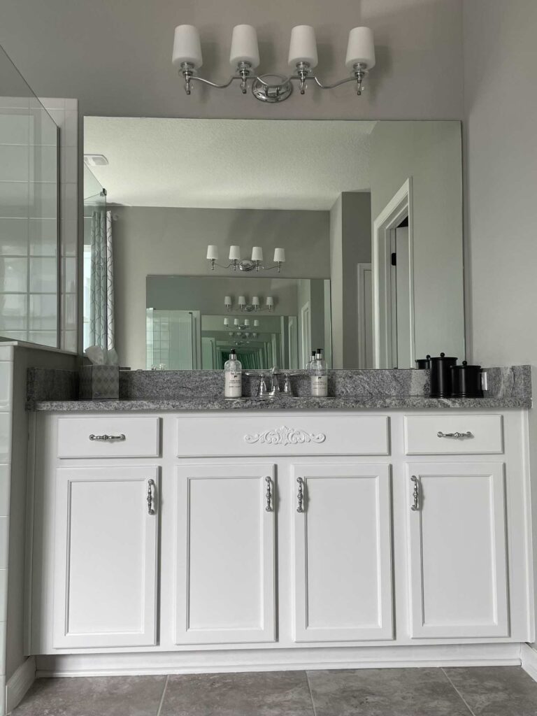 White bathroom cabinet with plain mirror. 