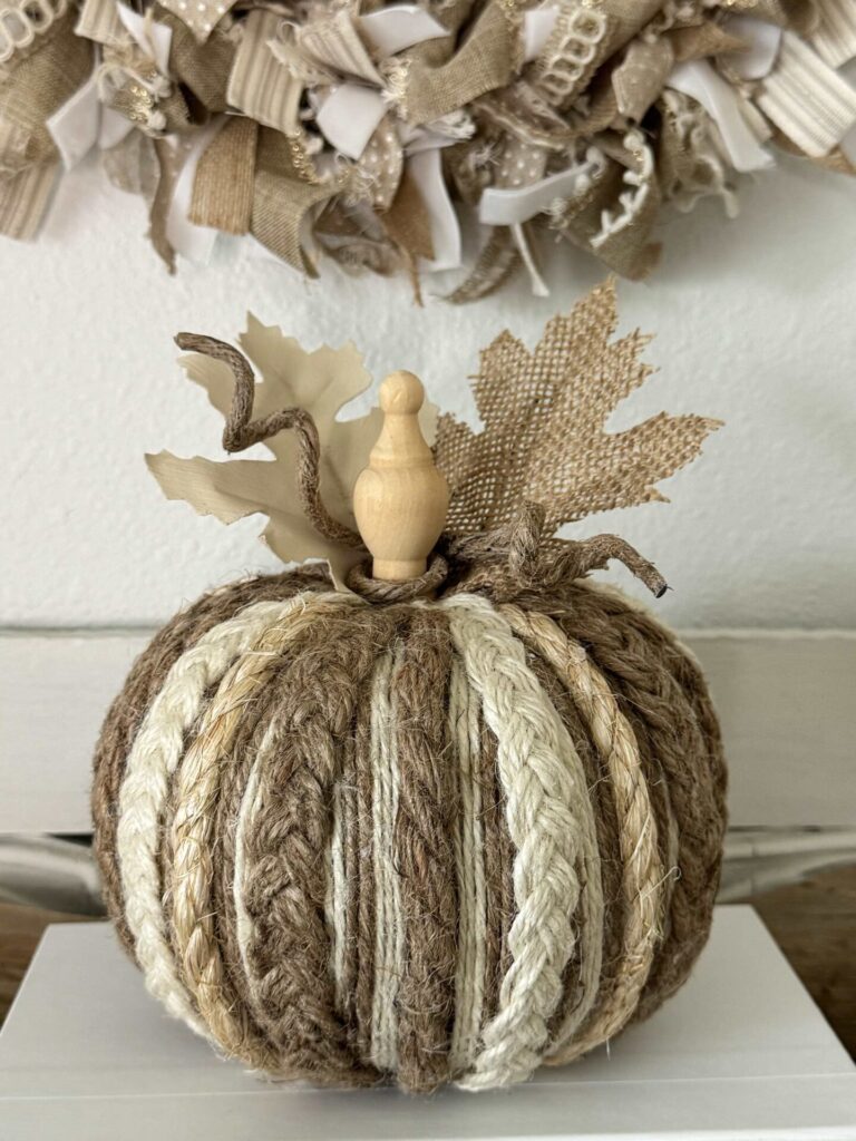 A DIY rope and twine pumpkin on a book. 