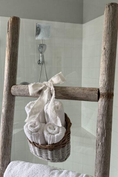 A basket of wash clothes tied to a towel ladder