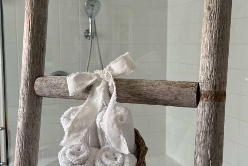 A basket of wash clothes tied to a towel ladder