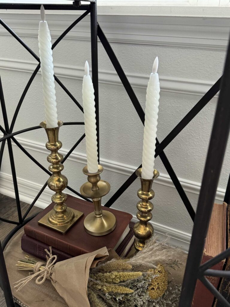 Brass candlesticks with white taper candles. 