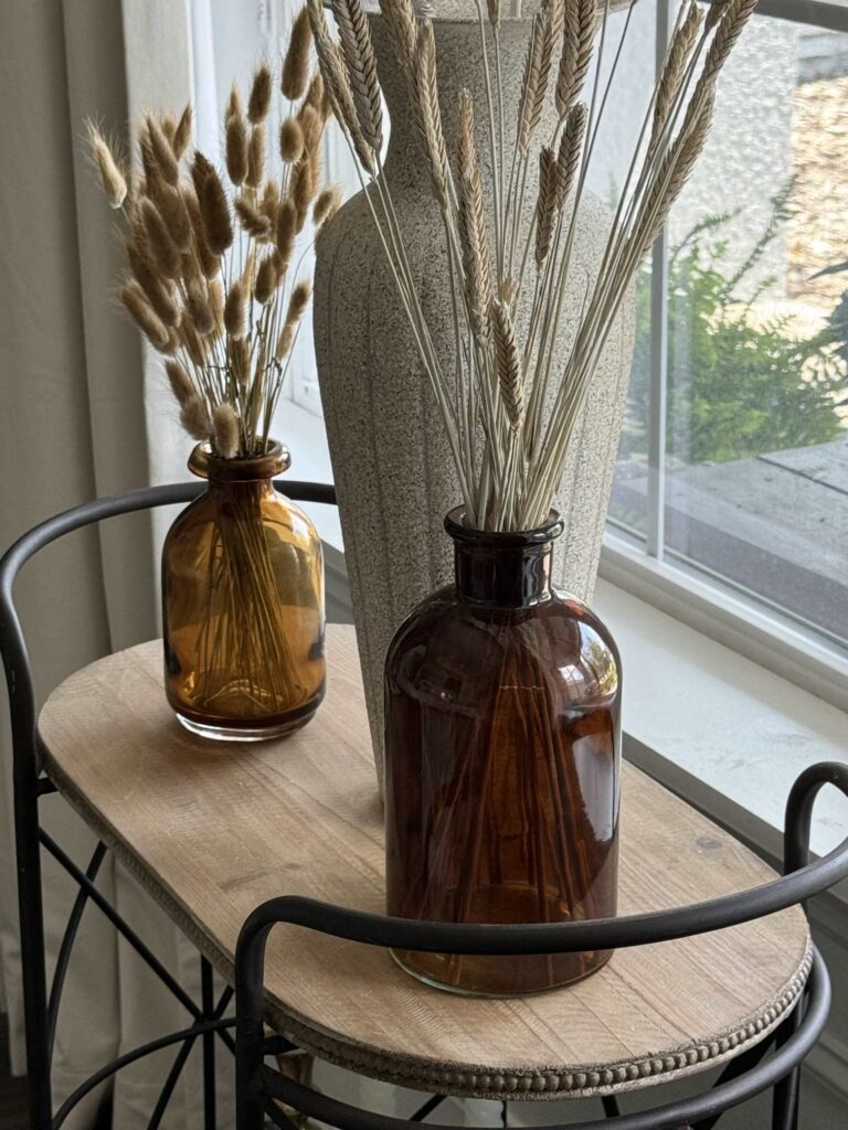 Wheat displayed in two amber glass bottles are an easy fall decorating idea.  