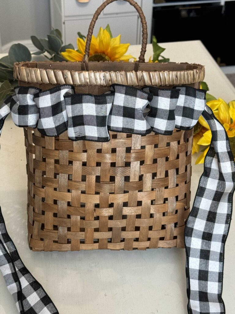 Black and white buffalo check ribbon weaved across the top of a basket.