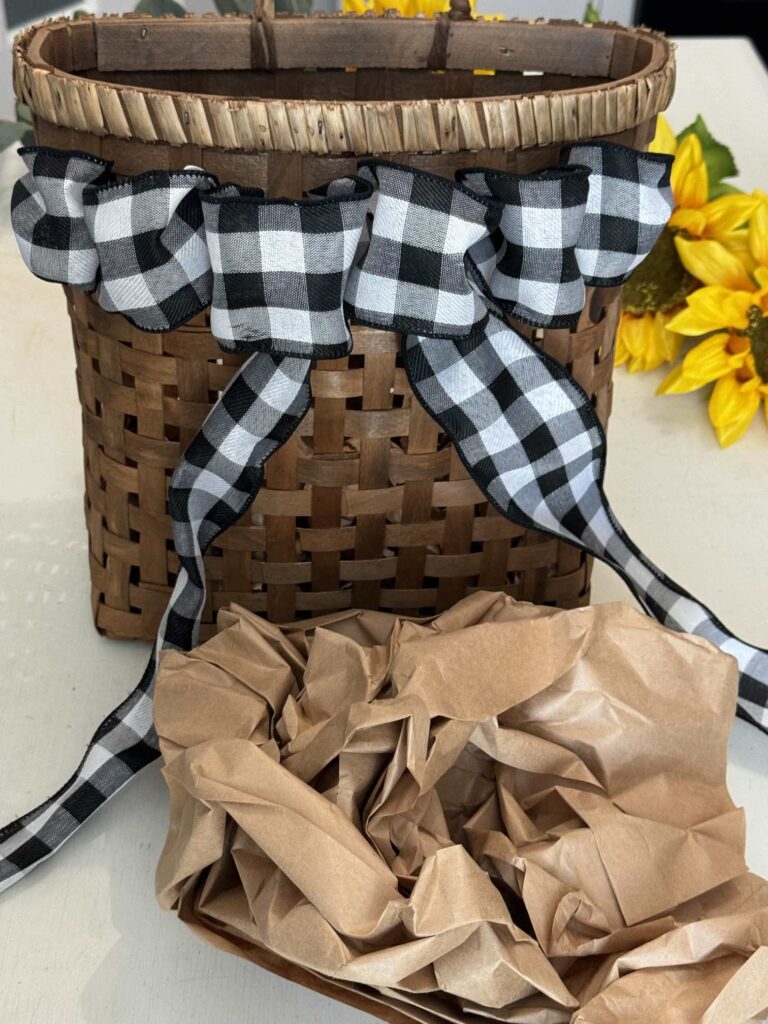 A basket with waded up packing paper in front of it. 