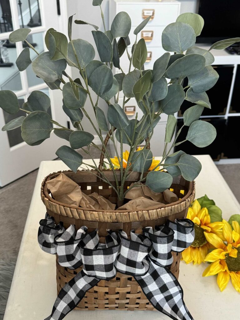 Step two to make a DIY sunflower wreath. is to put eucalyptus inside a basket. 