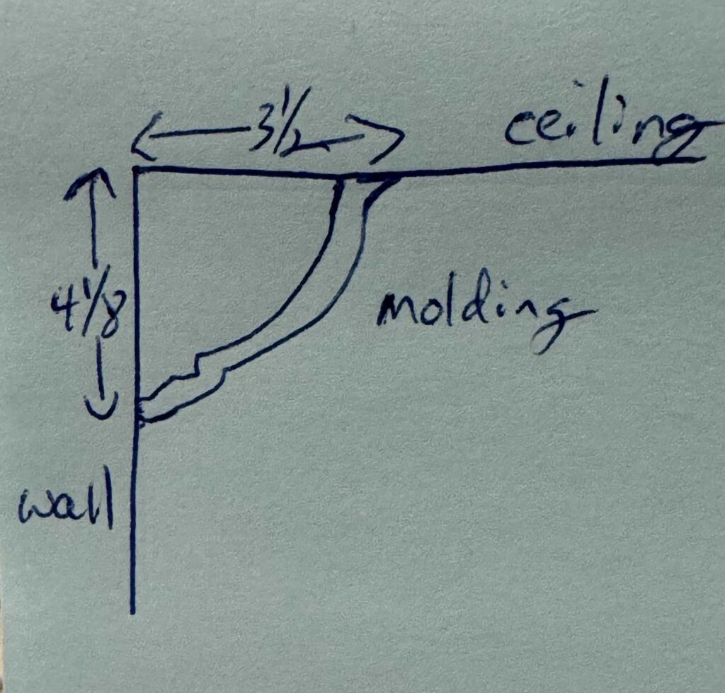 Drawing of profile of crown molding against wall and ceiling with measurements