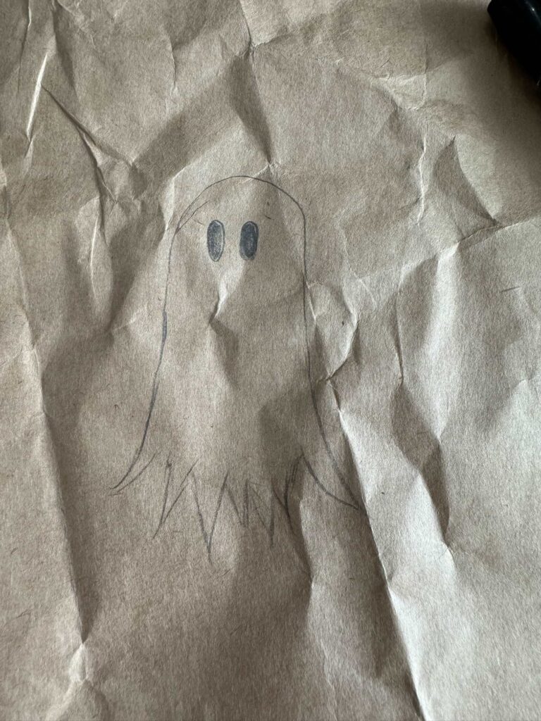 A ghost drawn in pencil on brown paper.