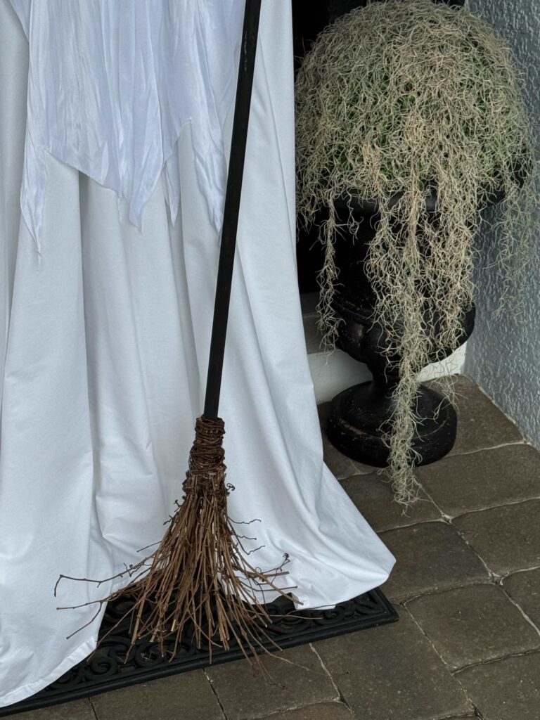 A broom being held by a DIY ghost. 