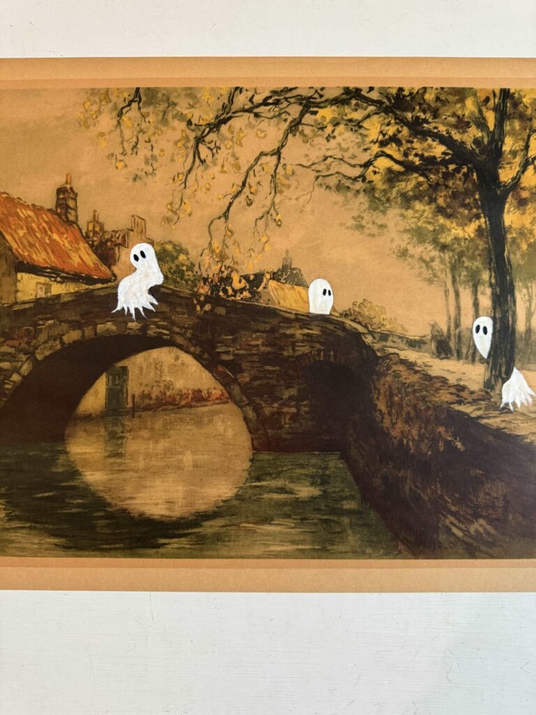 A picture of a bridge with three ghost painted on it. 