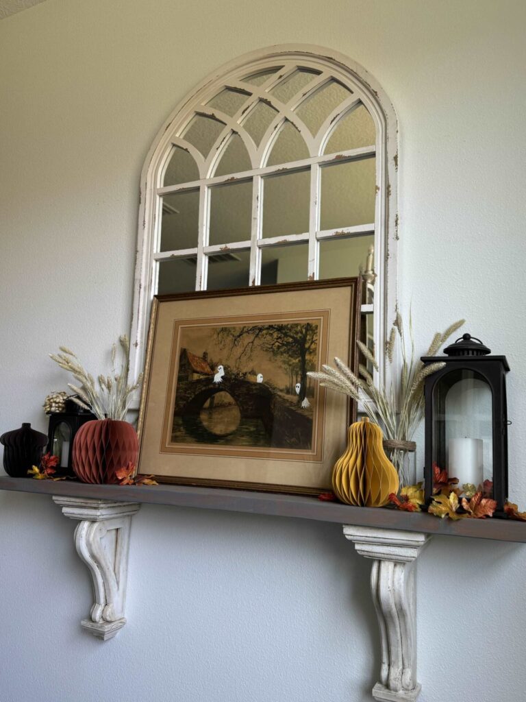 A ghost painting on a shelf with lanterns, wheat, and accordion items.