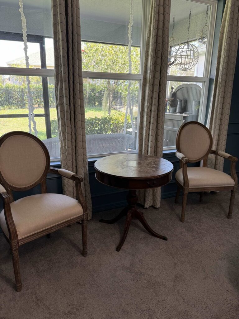 Bedroom sitting area with old, worn out table.  