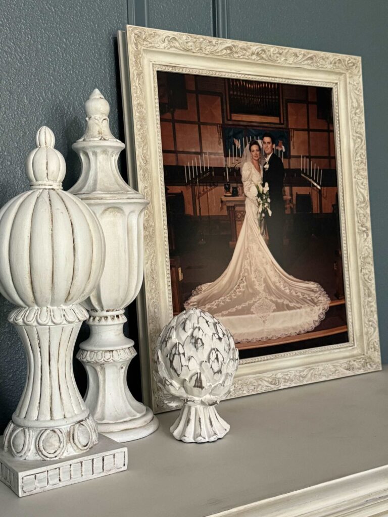 A wedding portrait, and three decorative finial statues. 