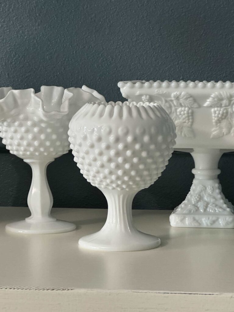 Bedroom makeover step seven is to decorate with thrifted finds like these three white milk glass bowls. 