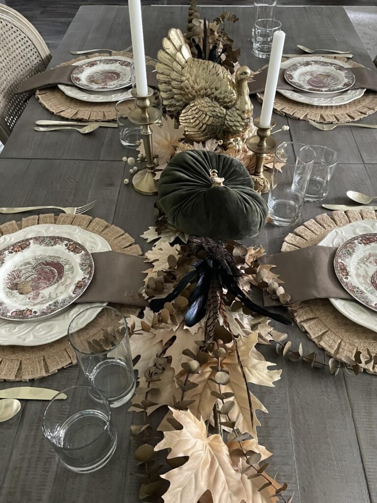 If you host Thanksgiving, decorate your table with a gold turkey, velvet pumpkins, brass candleholders. and turkey plates. 