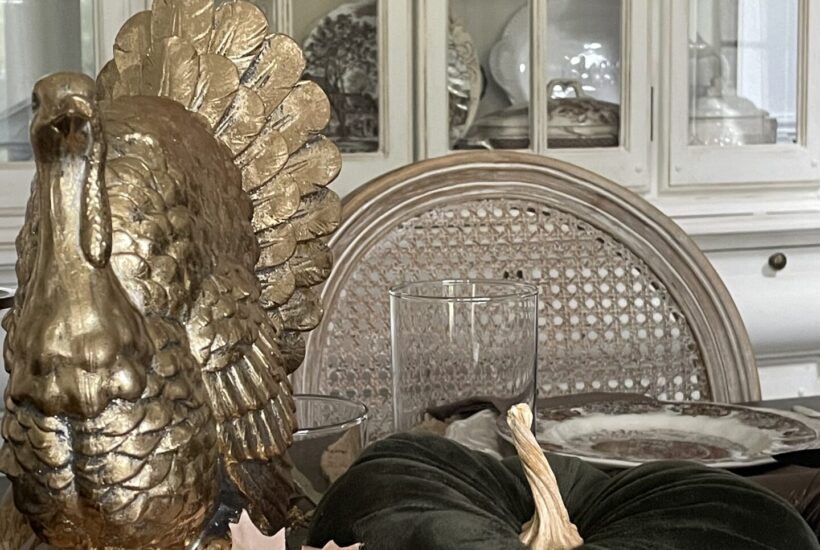 A gold turkey on a Thanksgiving table