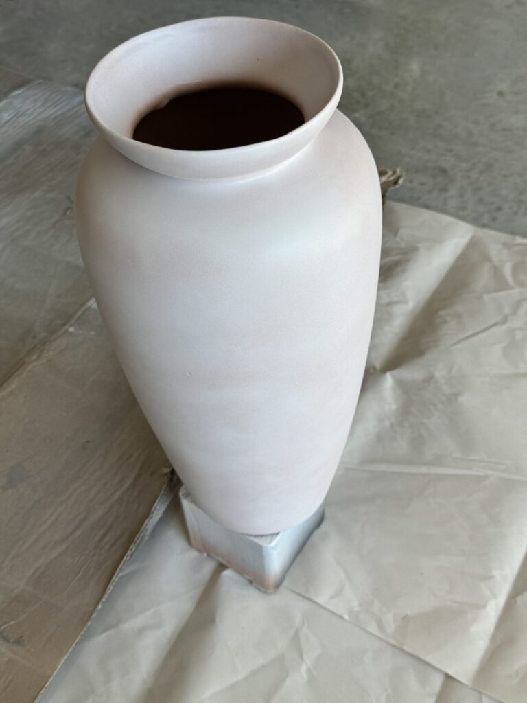 Step one to upcycle a vase is to spray it with primer. 