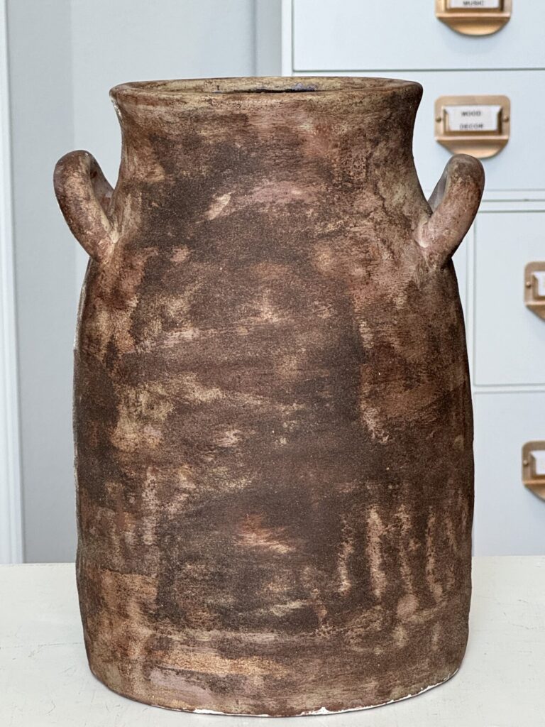 A brown yard sale vase. 