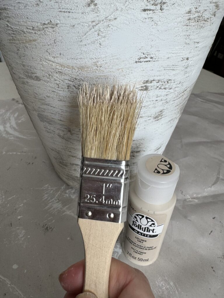 Step five to upcycle a vase is to apply a medium paint color with a chip brush.  