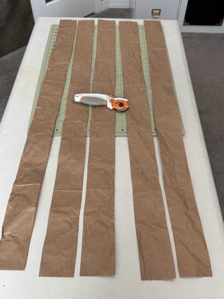 Packing paper cut into 3-inch wide strips with a rotary cutter. 