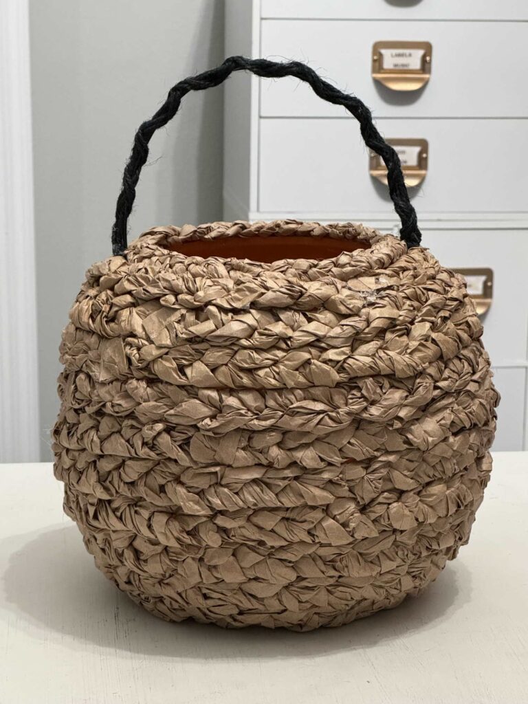 Handle of pumpkin basket with a black jute twine handle. 